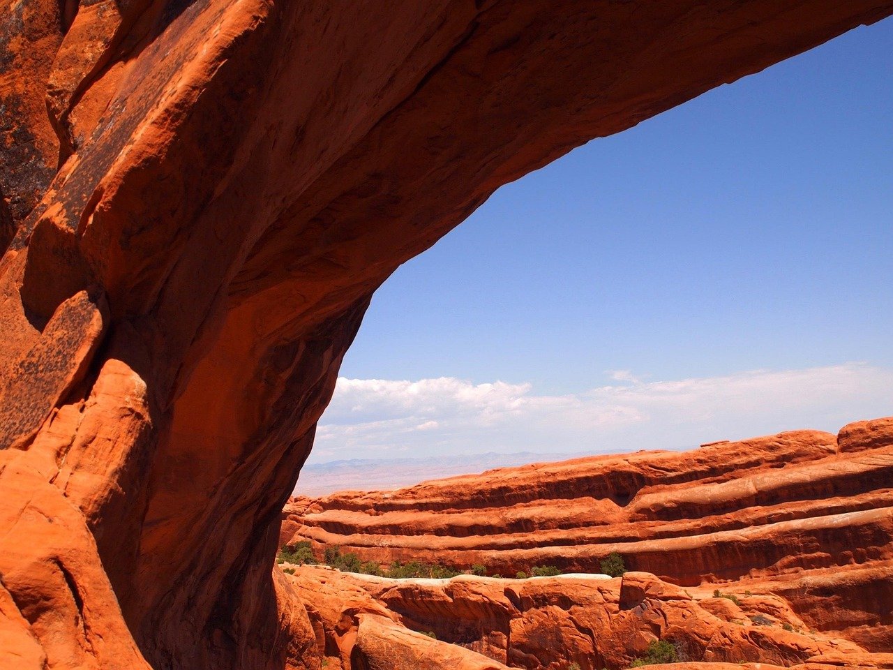 Desert landscape with red rock formations and blue sky