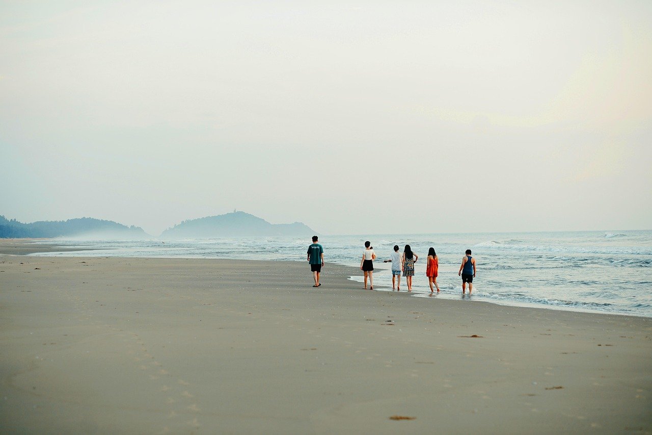 Group of friends enjoying beach sunset together