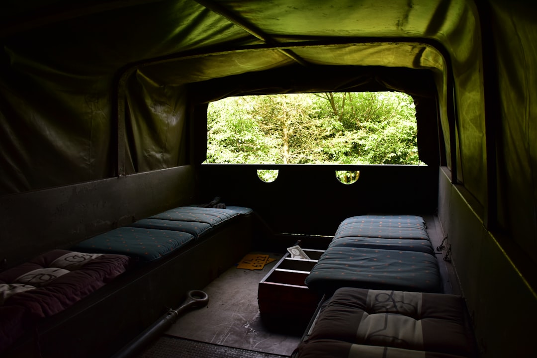 Cozy campervan bed interior with comfortable bedding and warm lighting