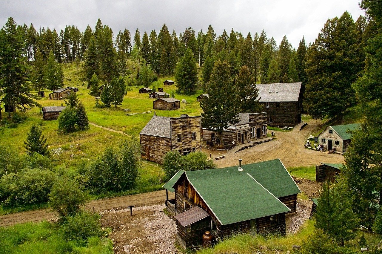 Historic mining town buildings with mountain backdrop