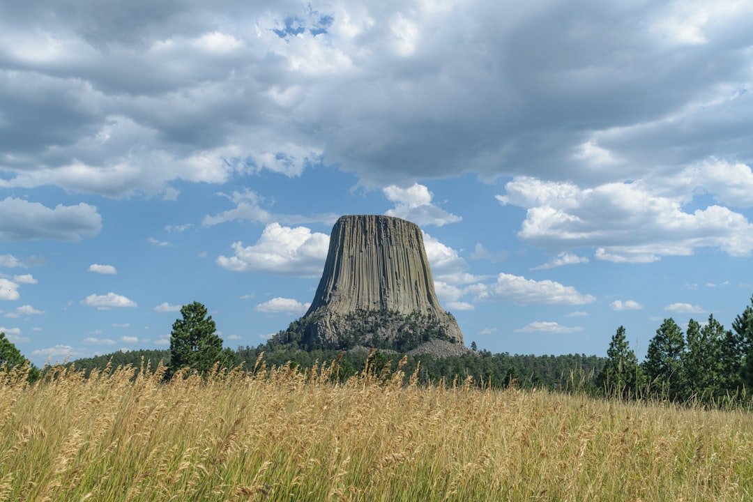 Devils Tower Wyoming volcanic rock monument with dramatic columns and spring sky