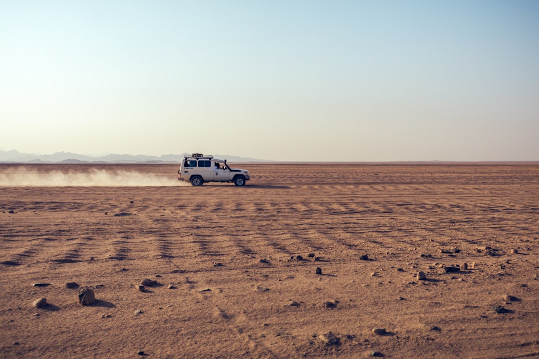 Campervan desert travel showing van in hot dry landscape with mountains