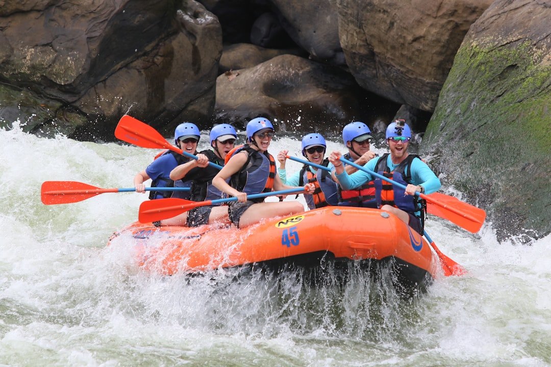 Whitewater rafting on a rushing river through mountain scenery