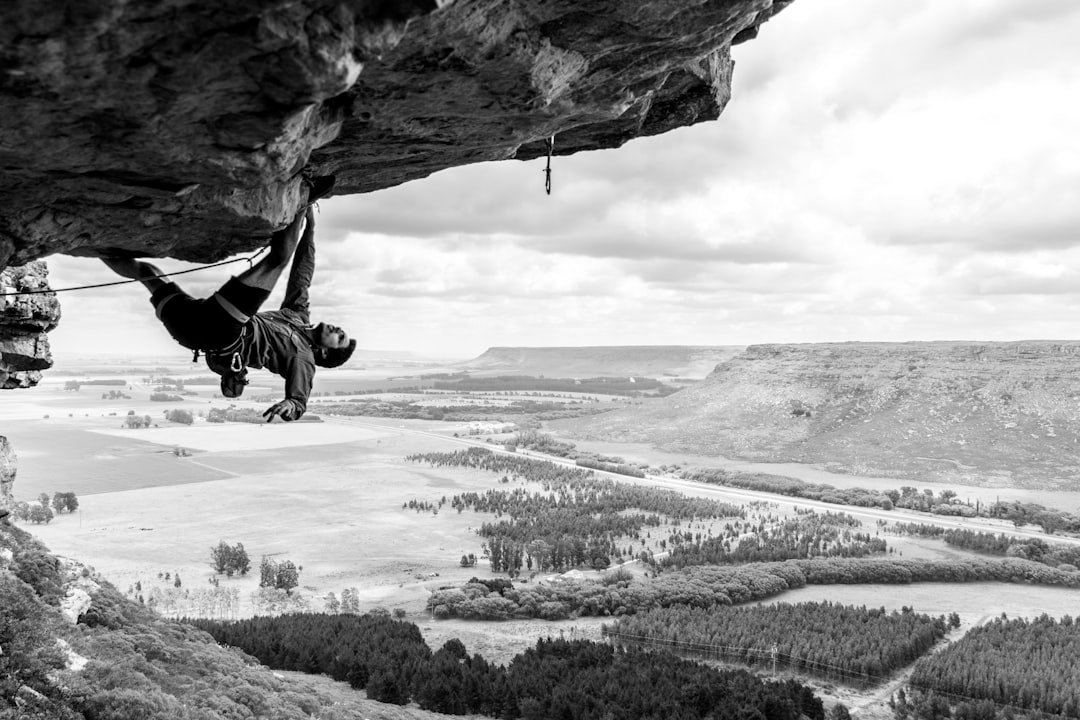 Rock climber scaling outdoor cliff face