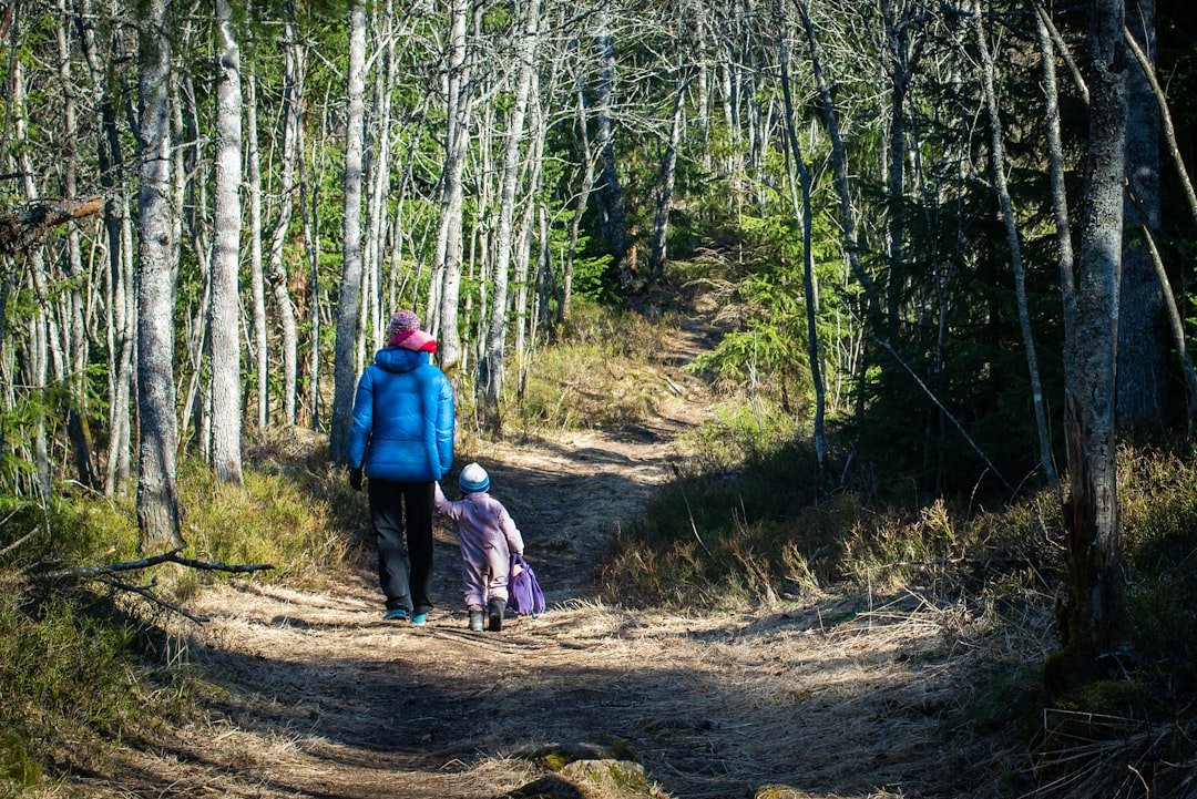 Mother and daughter walking together on a scenic trail
