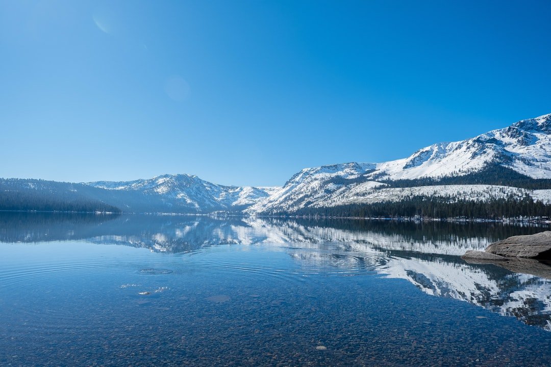 Mountain lake with crystal clear water reflecting peaks