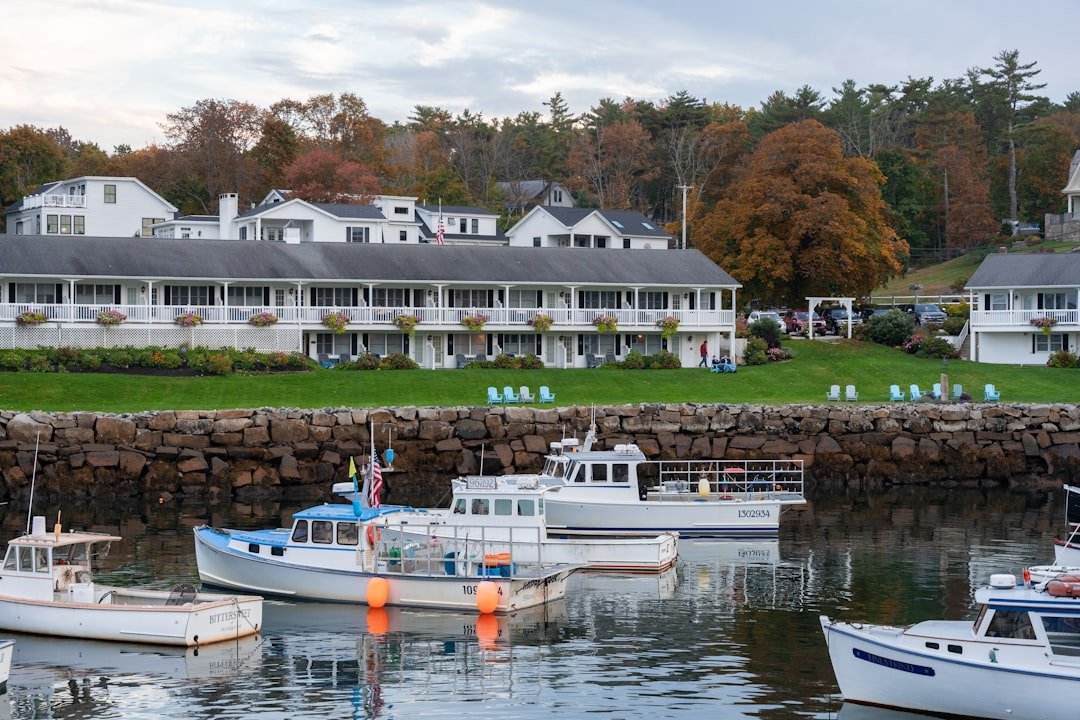 Maine harbor with fishing boats docked along a weathered wooden pier