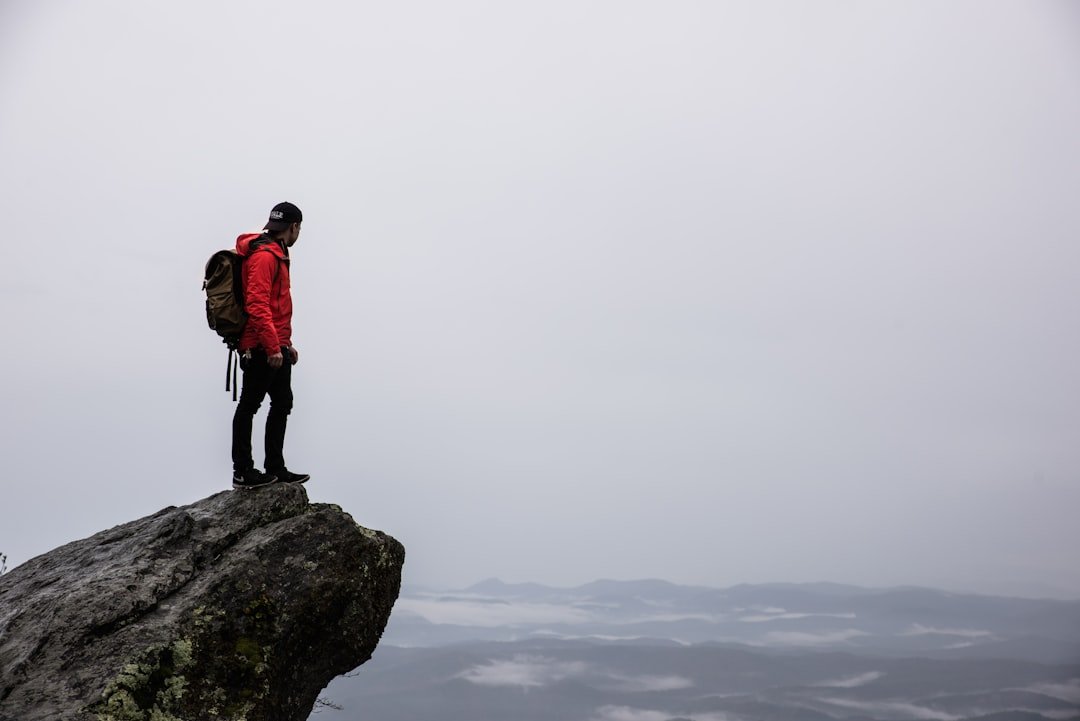 Hiker in rain jacket on mountain trail