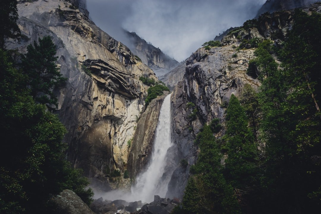 Hiker on Upper Yosemite Falls Trail with stunning views of Yosemite Valley
