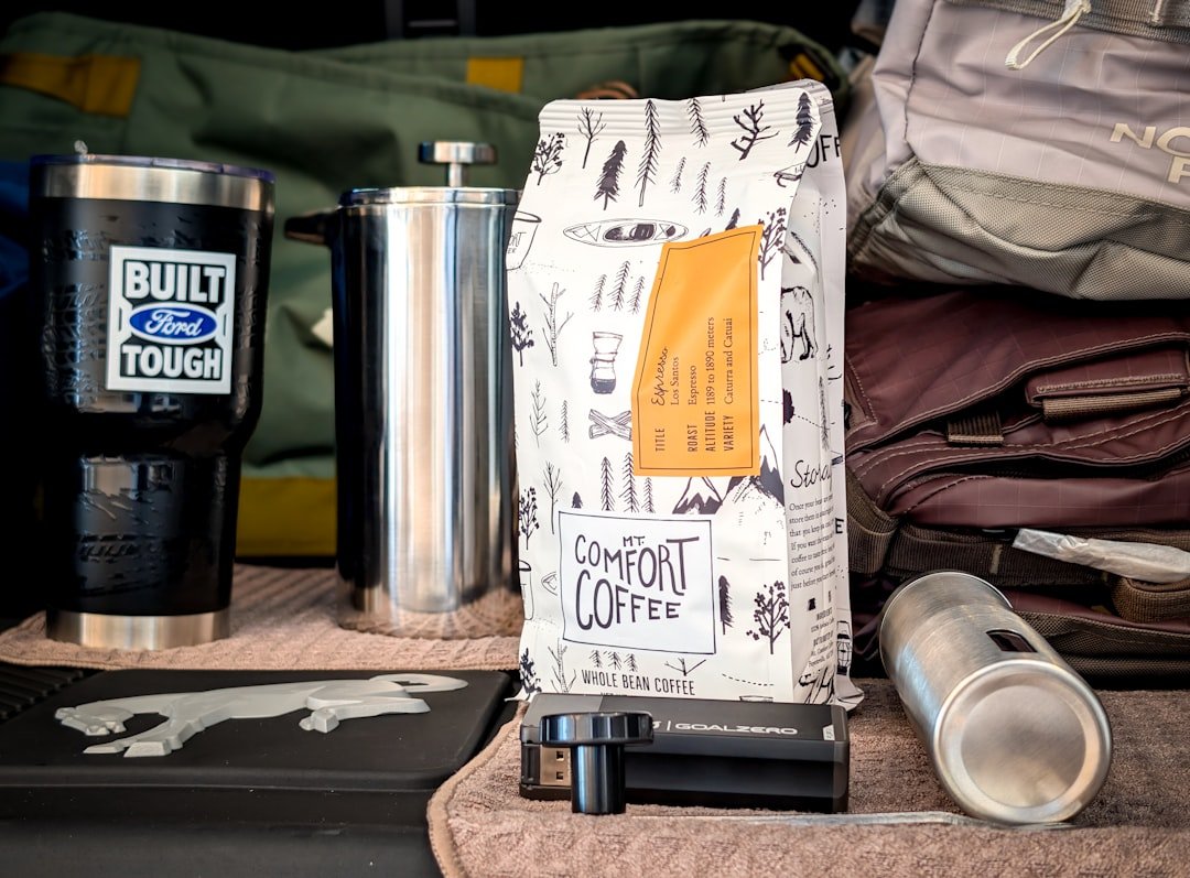 Fresh coffee beans and portable grinder
