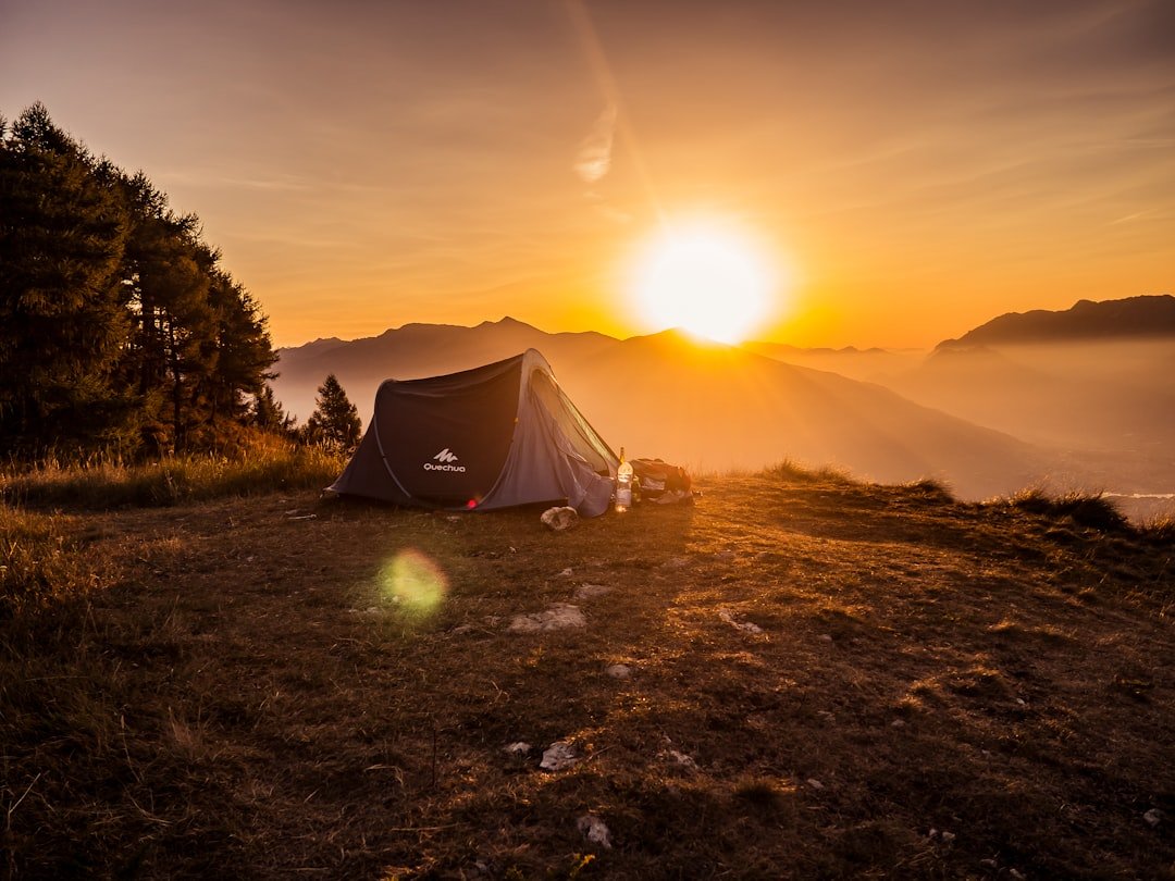 Camping tent set up in the mountains at dusk