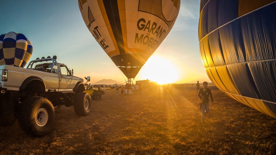 Hot air balloons rising over red rock formations at sunrise in Sedona