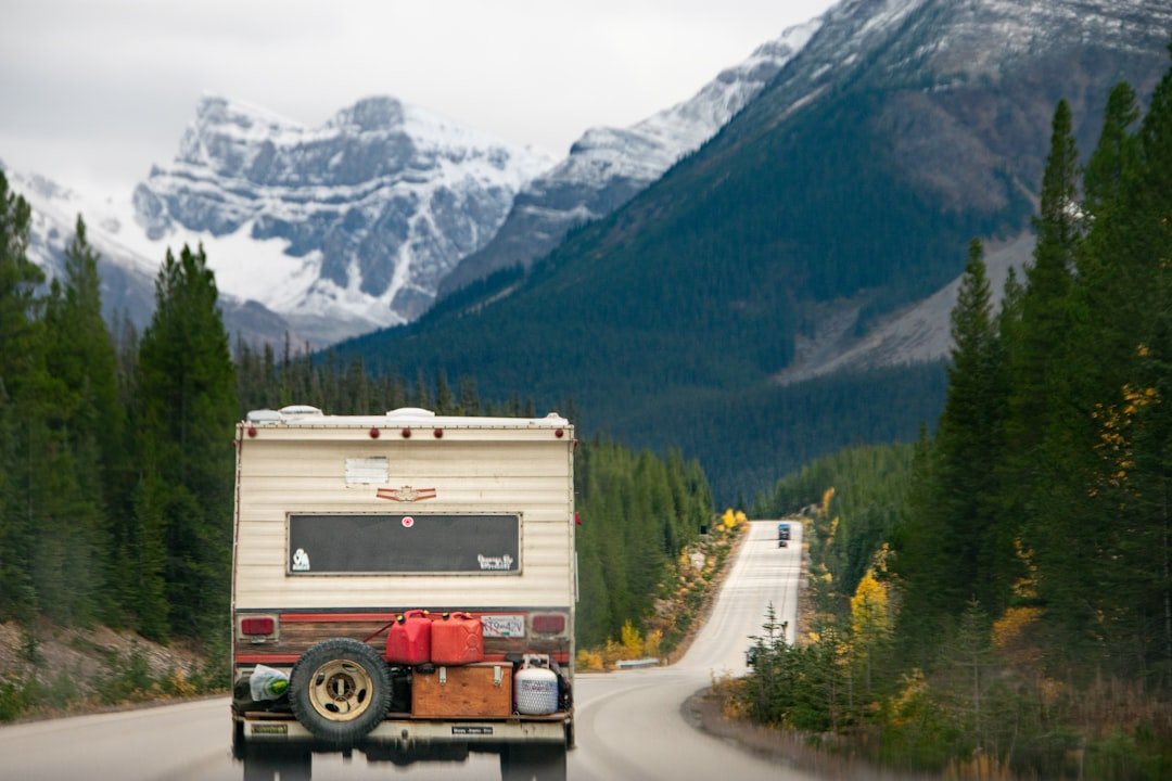 Truck pulling camper trailer on scenic highway
