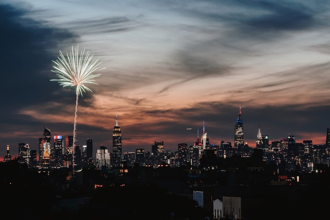 Fireworks erupting over the New York City skyline at night