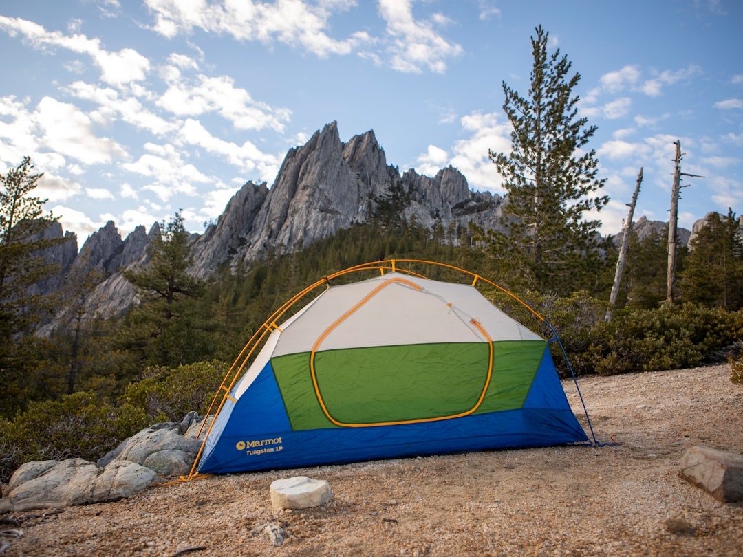 Camping tent set up with mountain backdrop