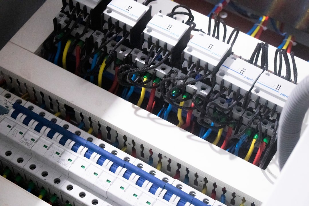 Partially built campervan interior showing electrical components mounted on plywood backing