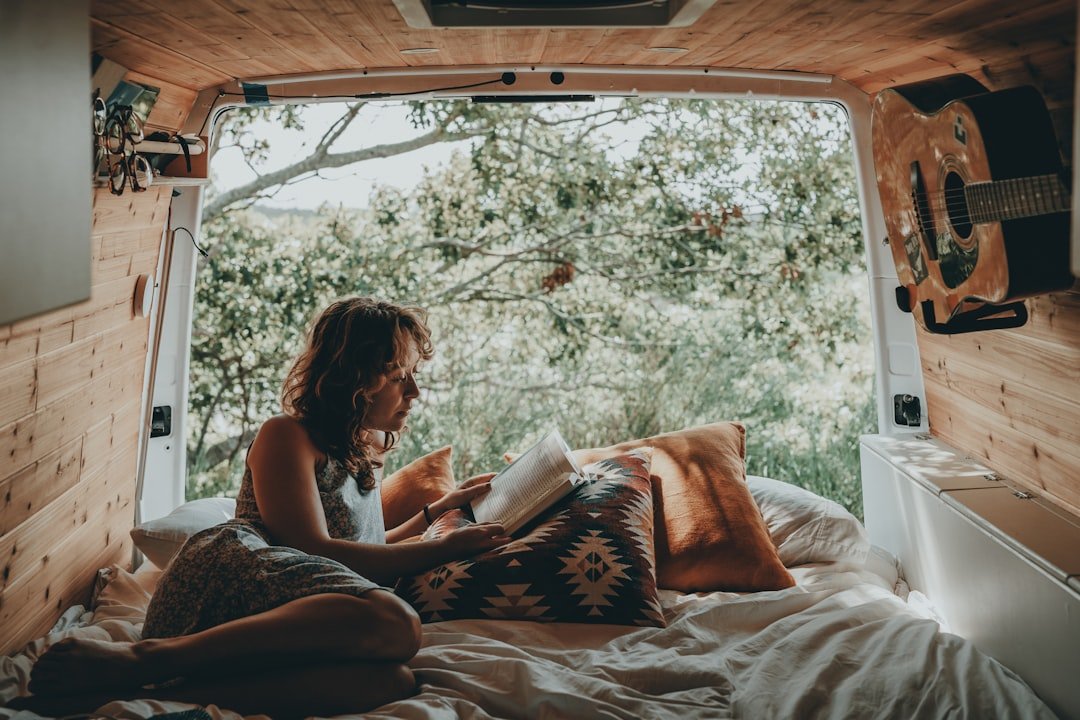 Campervan interior at night with warm lighting and comfortable sleeping area