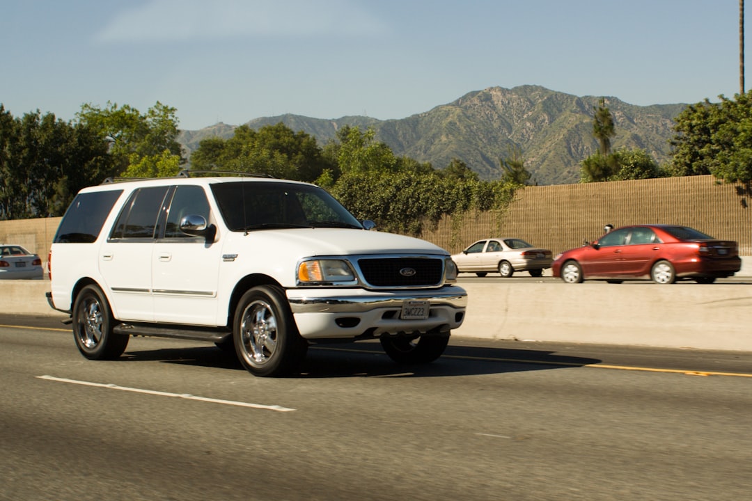 SUV traveling on a scenic highway with mountains in the distance
