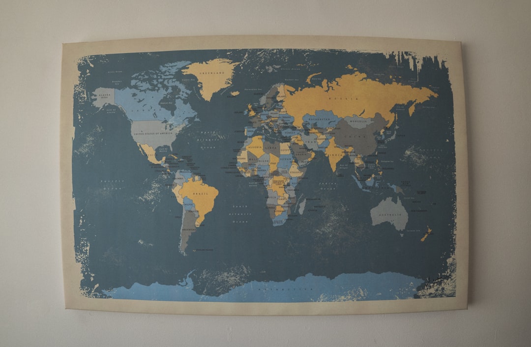 Colorful scratch-off world travel map on the wall, tracking family adventures