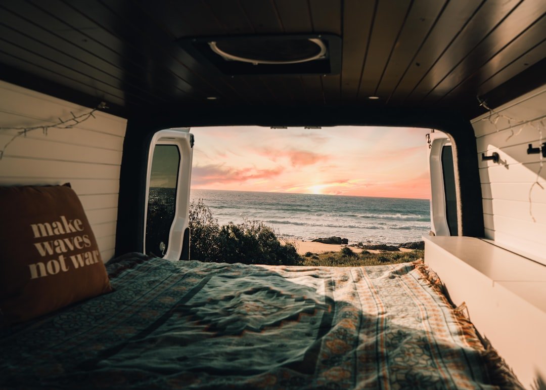 Campervan roof with vent fan installed overlooking scenic landscape