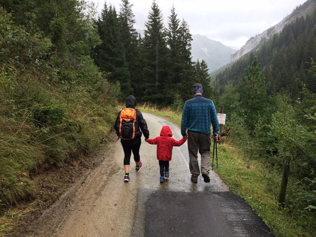 Family hiking in sturdy boots on a scenic trail through the wilderness