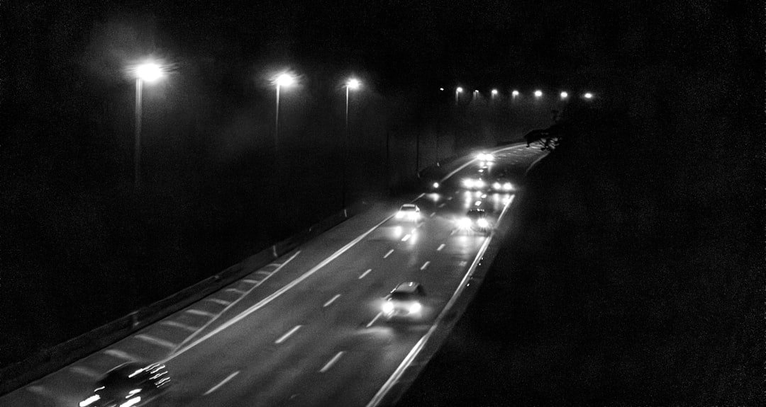 Night driving with headlights on dark road