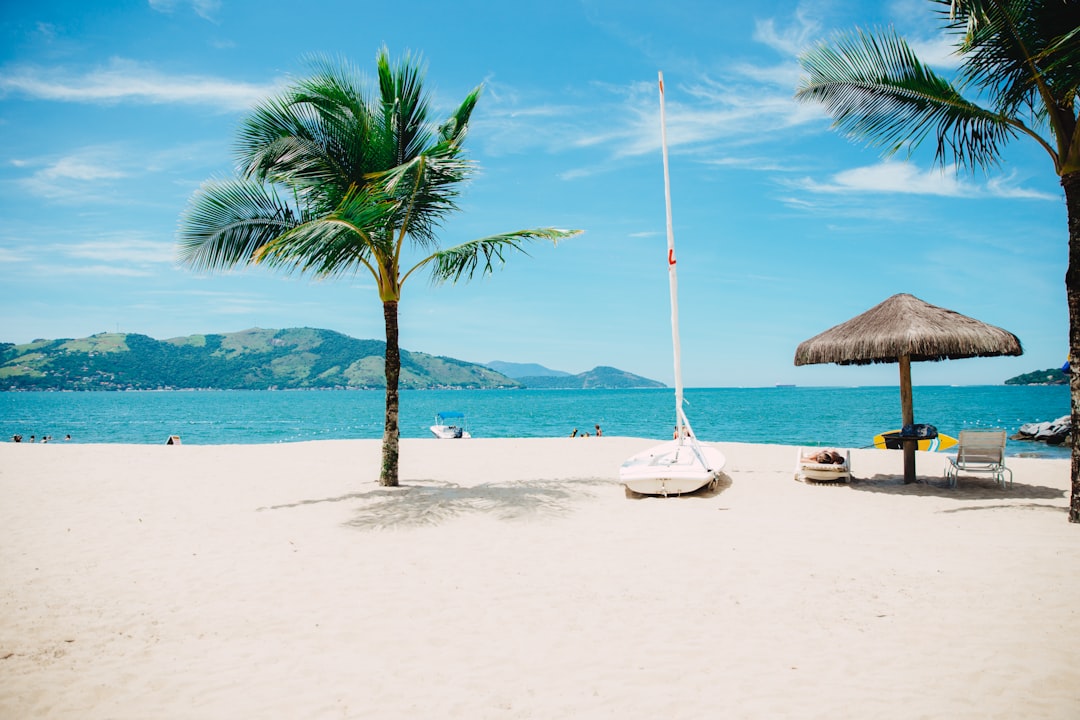 Beach umbrella and accessories on white sand