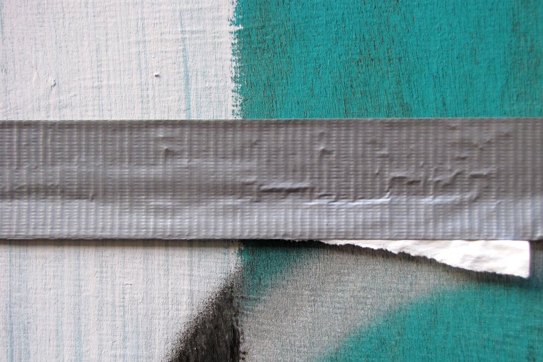 Butyl tape being applied to a surface for waterproofing