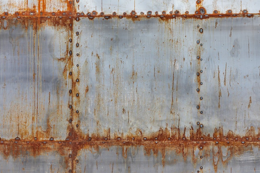 Rust preventative paint being applied to exposed metal edges after cutting