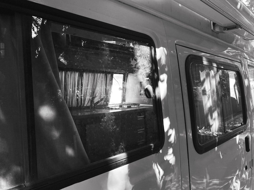 Van wall interior showing metal framework and insulation during window installation