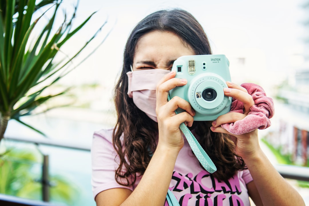 Traveler holding an instant camera, ready to capture road trip memories