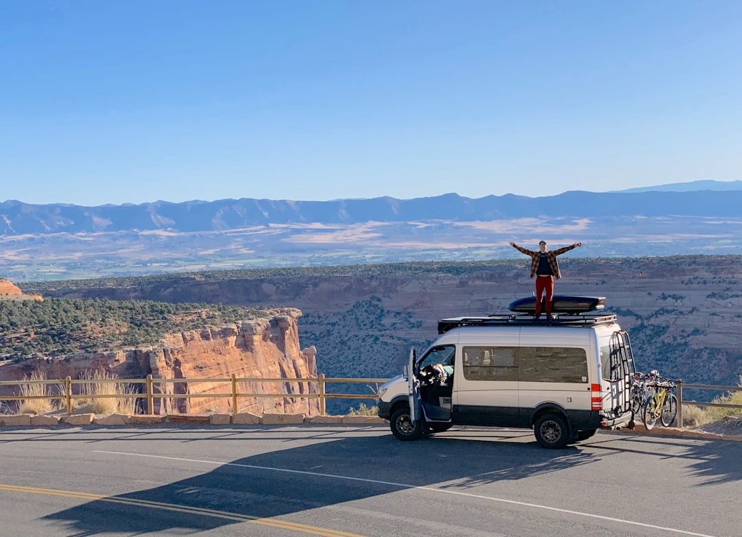 Campervan with windows parked at scenic mountain overlook during road trip