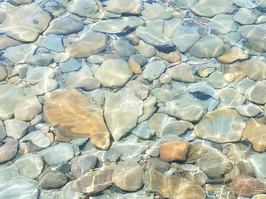 Clear river water flowing through natural rocks