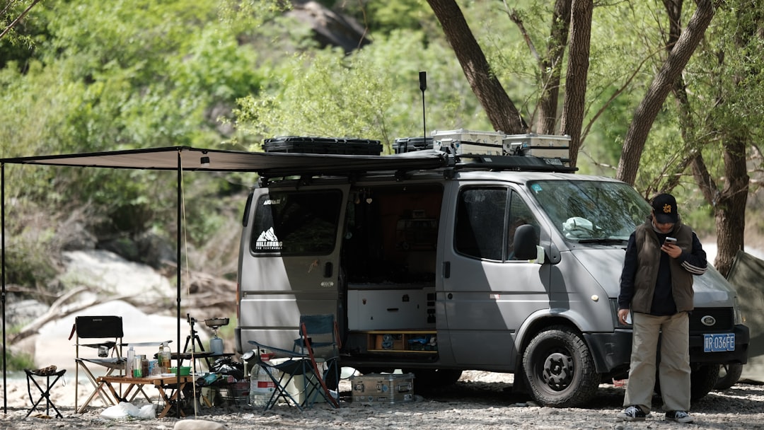 Off-grid camper van parked in scenic landscape
