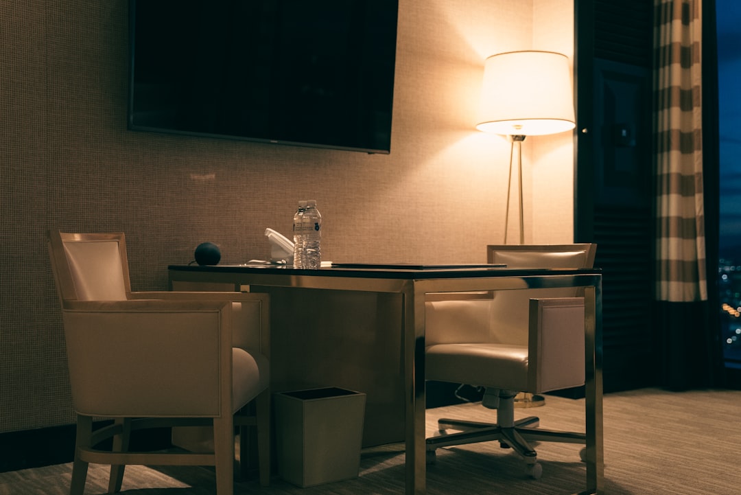 Laptop charging on hotel desk while traveling