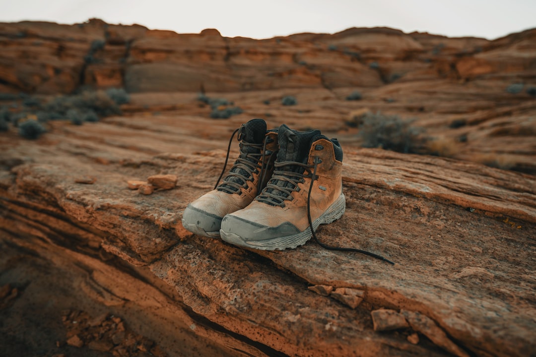 Well-worn hiking boots on a trail in morning light