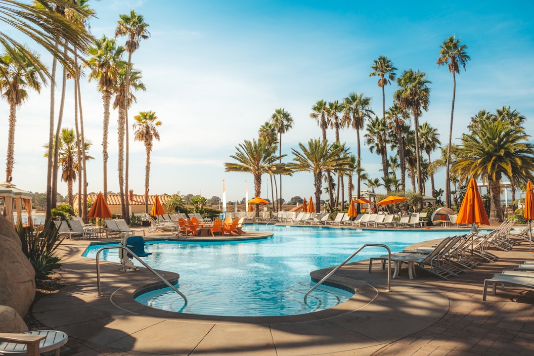 Resort pool with plenty of open lounge chairs in late August