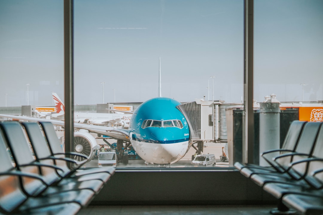 Airport terminal with travelers waiting at their gate
