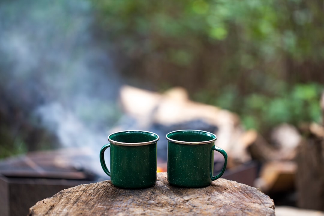 A thermos pouring hot chocolate at a campsite