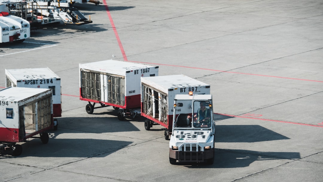 Baggage handlers loading luggage onto a plane on the tarmac