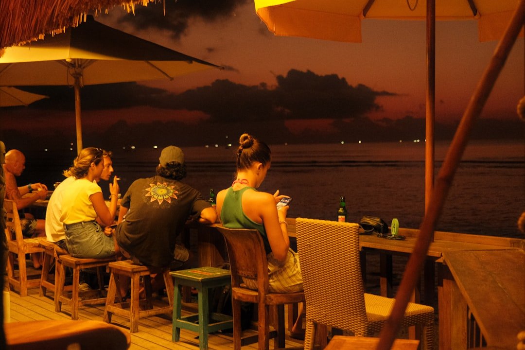 Waterfront tiki bar with outdoor seating overlooking the water