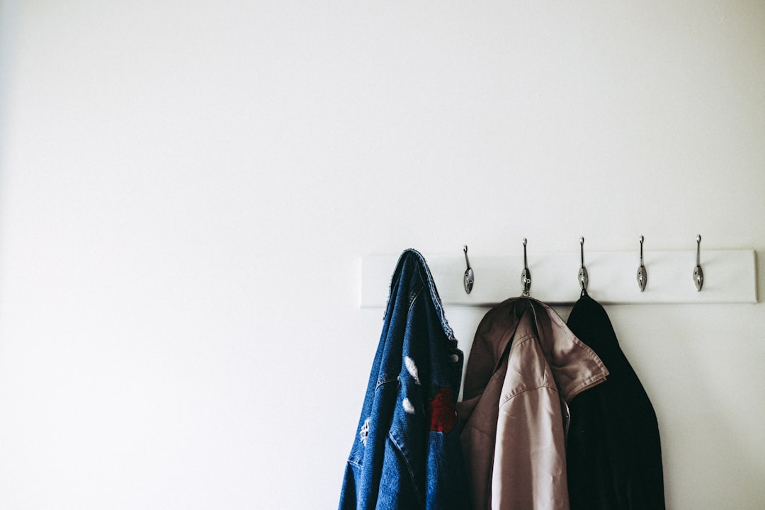 Rain jacket hanging on a door hook to dry