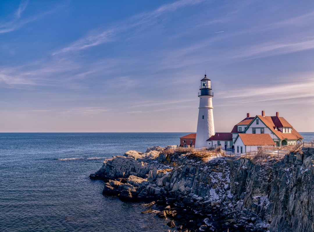 New England lighthouse on a rocky coastal point