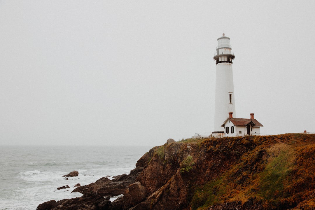 Lighthouse and dramatic island cliffs