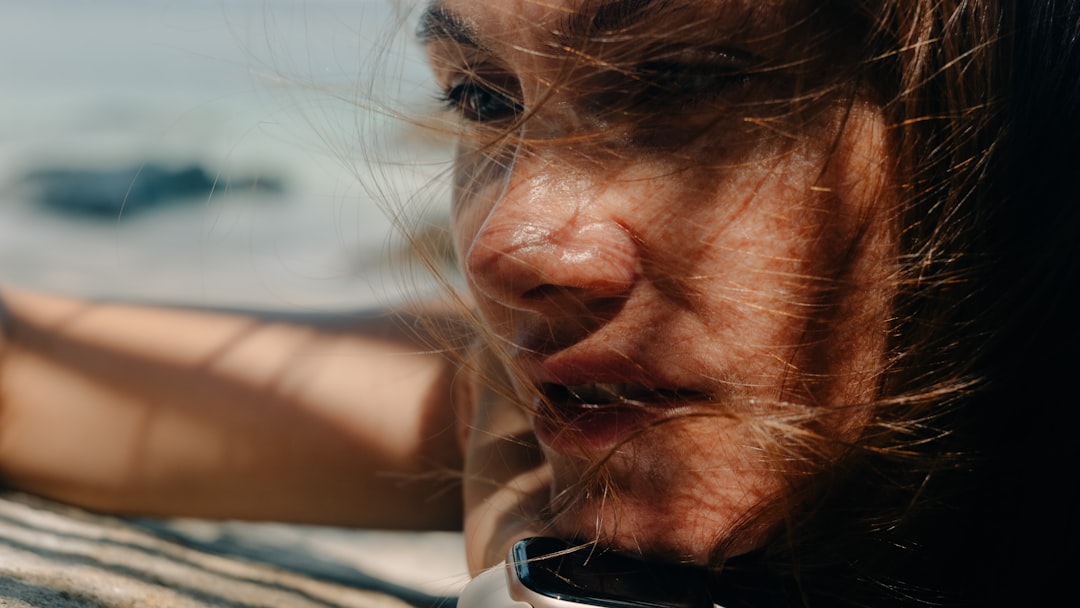 Applying sunscreen to exposed skin before outdoor activity