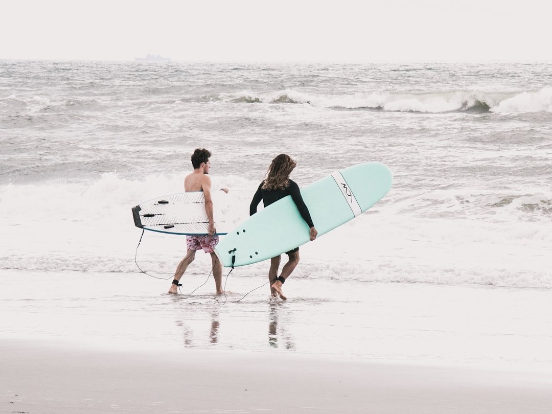 Surfers riding waves at Jacksonville Beach Florida