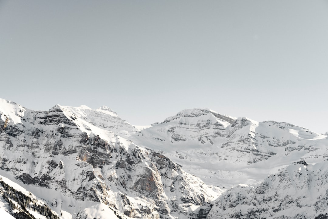 Glacier-carved mountain peaks rising above alpine terrain