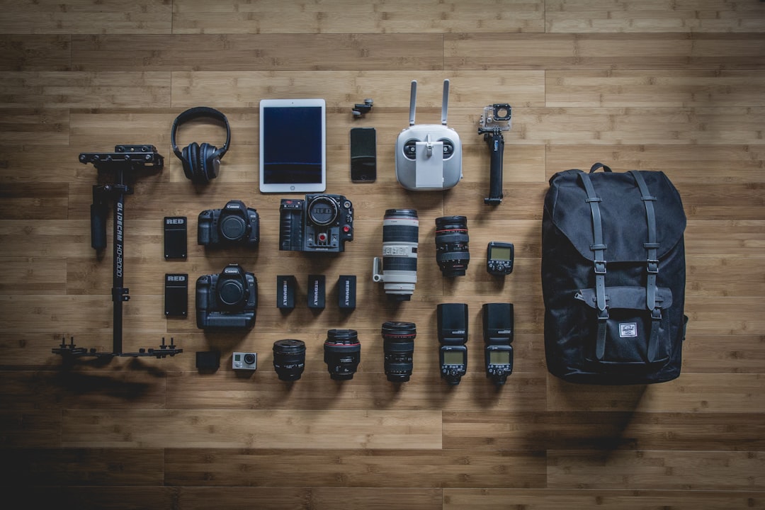 Camera gear including tripod accessories laid out flat