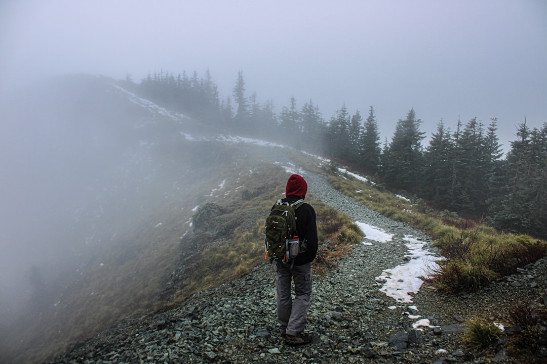 Hiker caught in rain storm on a mountain trail