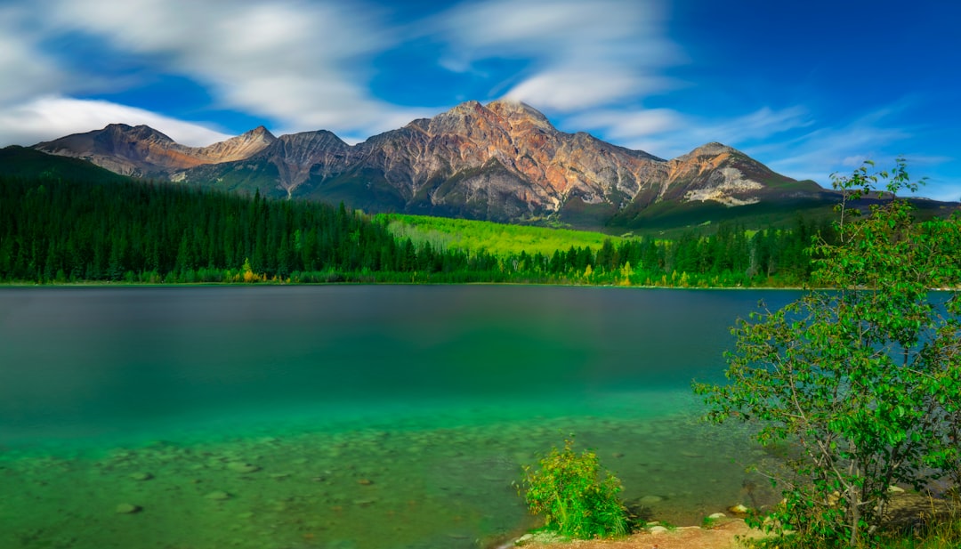 Peaceful mountain lake reflecting peaks in late summer